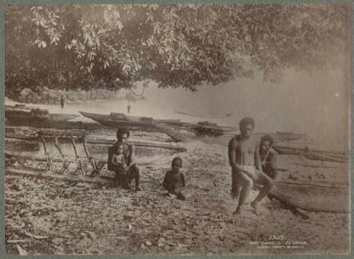 Men and children with war canoes