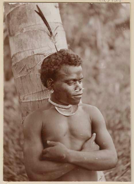 Man standing against tree