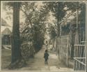 Children playing in fenced path, mother and child