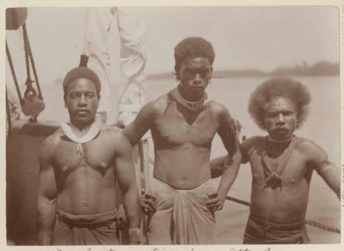 Three men of Atta Cove standing on a ship