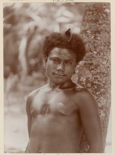 Man standing next to a tree