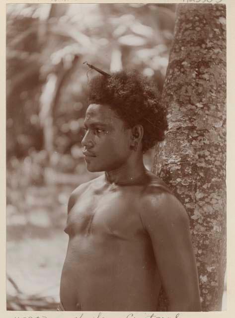 Man standing next to a tree