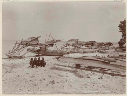 Children next to canoes at Pileni