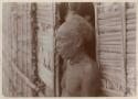 Man standing in front of thatched structure