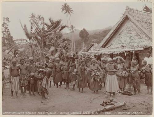 Women bringing present of food for ship