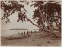 People and canoe on beach at Buala, with Kumaigola Island in background