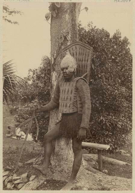 Kiribati warrior with shark tooth weapon (taumangaria) and helmet of porcupine fish skin