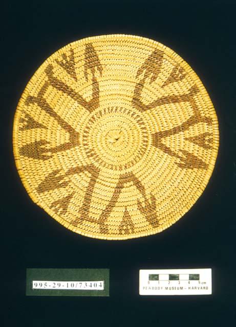 Coiled circular plaque with arrow motif