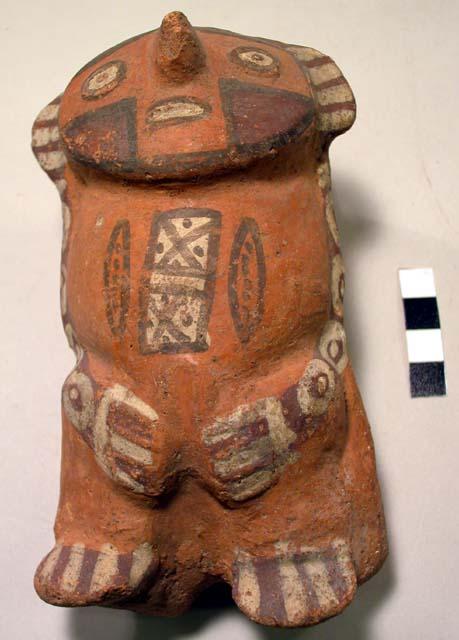 Pottery figurine- bulbous man;  Painted with white, brown and tan