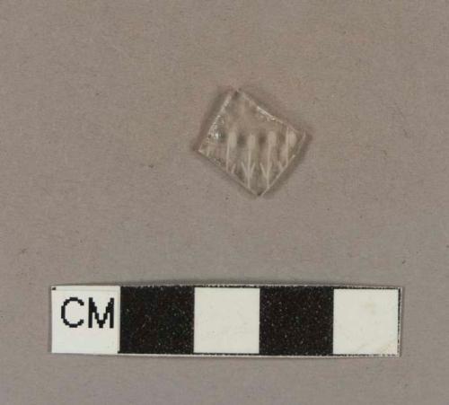 Etched colorless bottle glass fragment