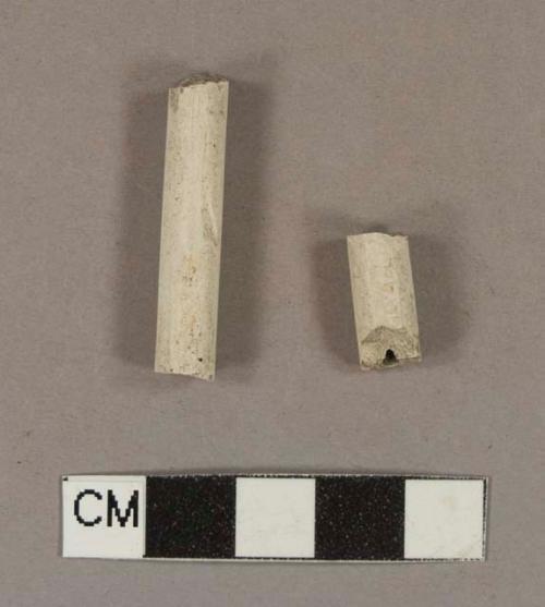 Unsmoked pipe stem fragments, stamped with illegible maker's mark; 5/64" bore diameter; two fragments crossmend