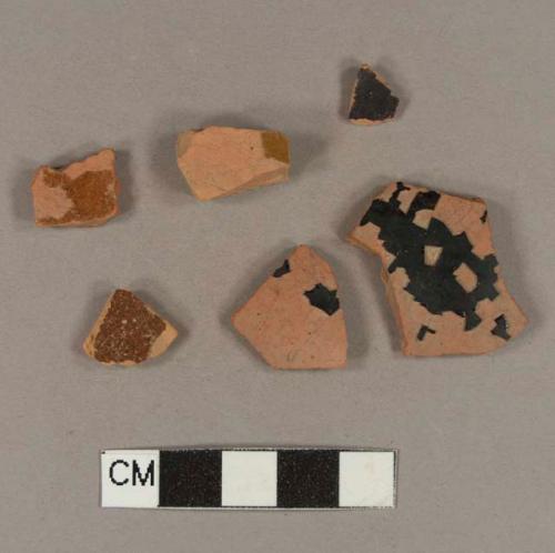 Undecorated lead glazed redware body sherds; two sherds crossmend