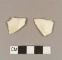 Undecorated creamware rim sherds; two sherds crossmend