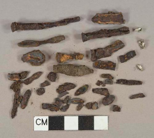 Ferrous metal nail fragments, heavily corroded, 3 aluminum foil fragments