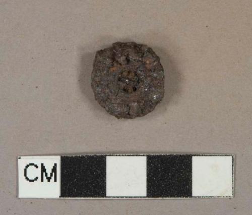 Ferrous alloy button, heavily corroded