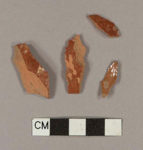 Undecorated lead glazed redware body sherds; two sherds crossmend