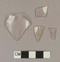 Molded colorless bottle glass fragments; four fragments crossmend