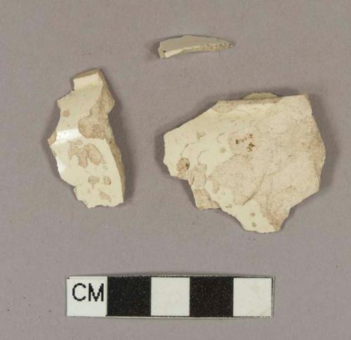 Undecorated creamware base sherds; two sherds crossmend