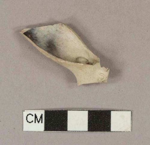 Smoked pipe bowl and heel fragment; bowl incised with cartouche; heel stamped on either side with "T" and "D"