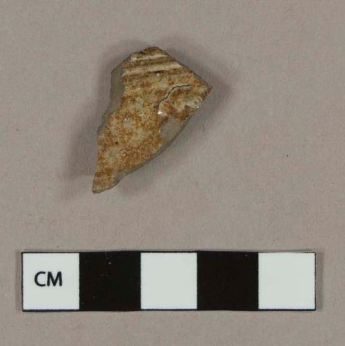 Molded, brown slipped salt glaze stoneware body sherd