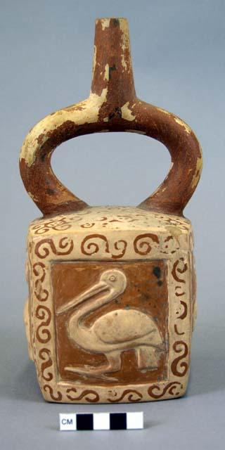 Ceramic bottle, stirrup spout, square body, brown and cream, bird motif in relie