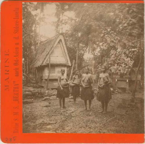 Four women standing in front of a house