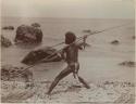 Man with spear on beach at Ahia