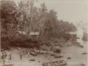 People, canoes and houses along shore at Ahia