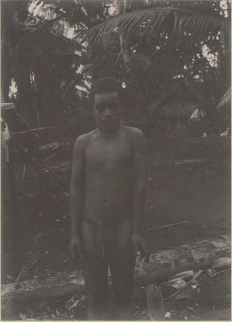 Man standing, with houses in background