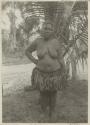 Woman standing in front of palm