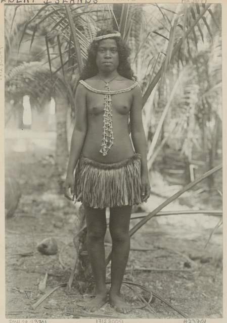 Woman standing in front of palm