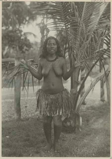 Woman standing in front of palm