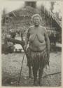 Woman standing in front of house