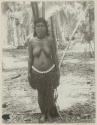 Woman standing in front of palm