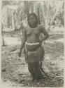 Woman standing in front of palm