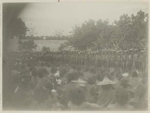 Large group sitting and standing around and on fort