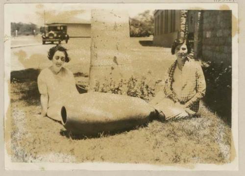 Two women sitting with knobbed ware vessel