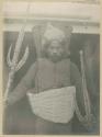 Man with taumangaria, coconut fiber armor and porcupine fish helmet