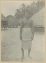 Man standing, with houses in background