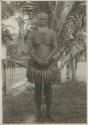 Man standing in front of palm