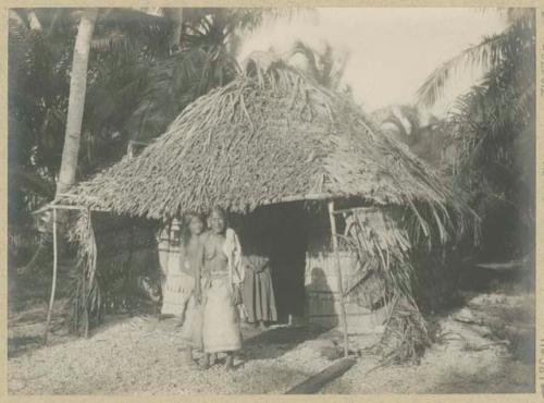 Woman and child in front of house