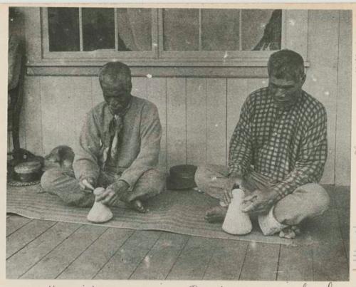 Men on porch shaping poi pounders