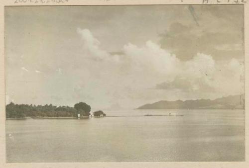 Shoreline with a view of  hills in the distance.