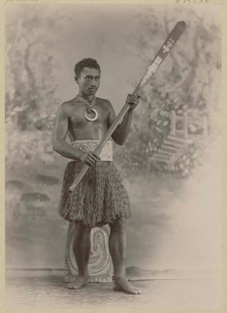 Studio portrait of a man holding a club