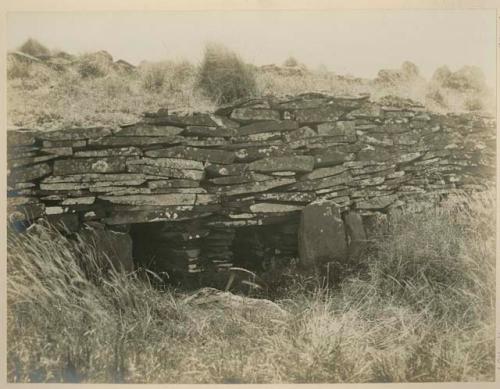 Stone house with two openings and ornamented door jambs