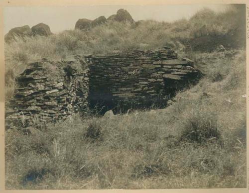 Stone house, with carved rocks in background