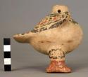 Small anthropomorphic pottery jar with wings, tail and feet (one missing); perfo