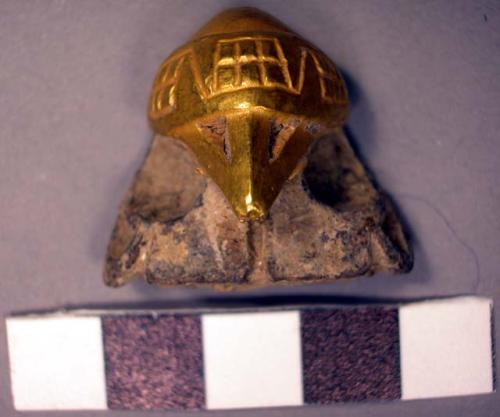 Gold-covered stone bird heads