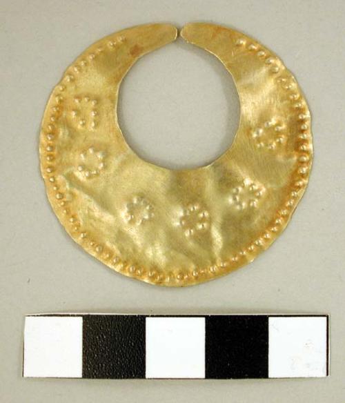 Circular gold mouth mask with repousse dot design