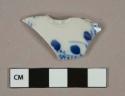 Blue on white handpainted porcelain vessel body fragment, likely lid fragment, white paste